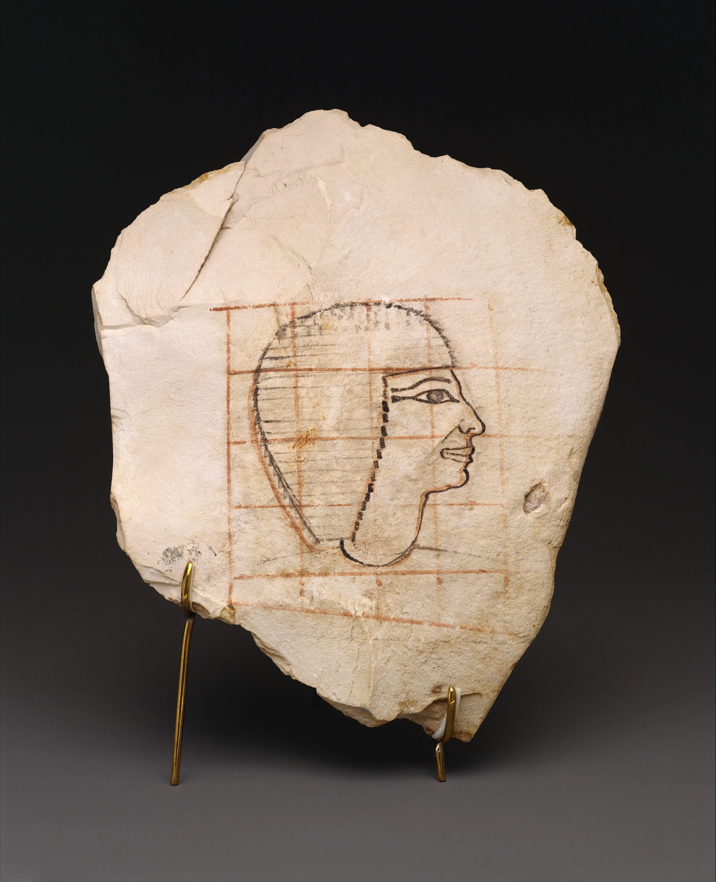 An ancient Egyptian sketch of Senenmut with the red grid lines still visible