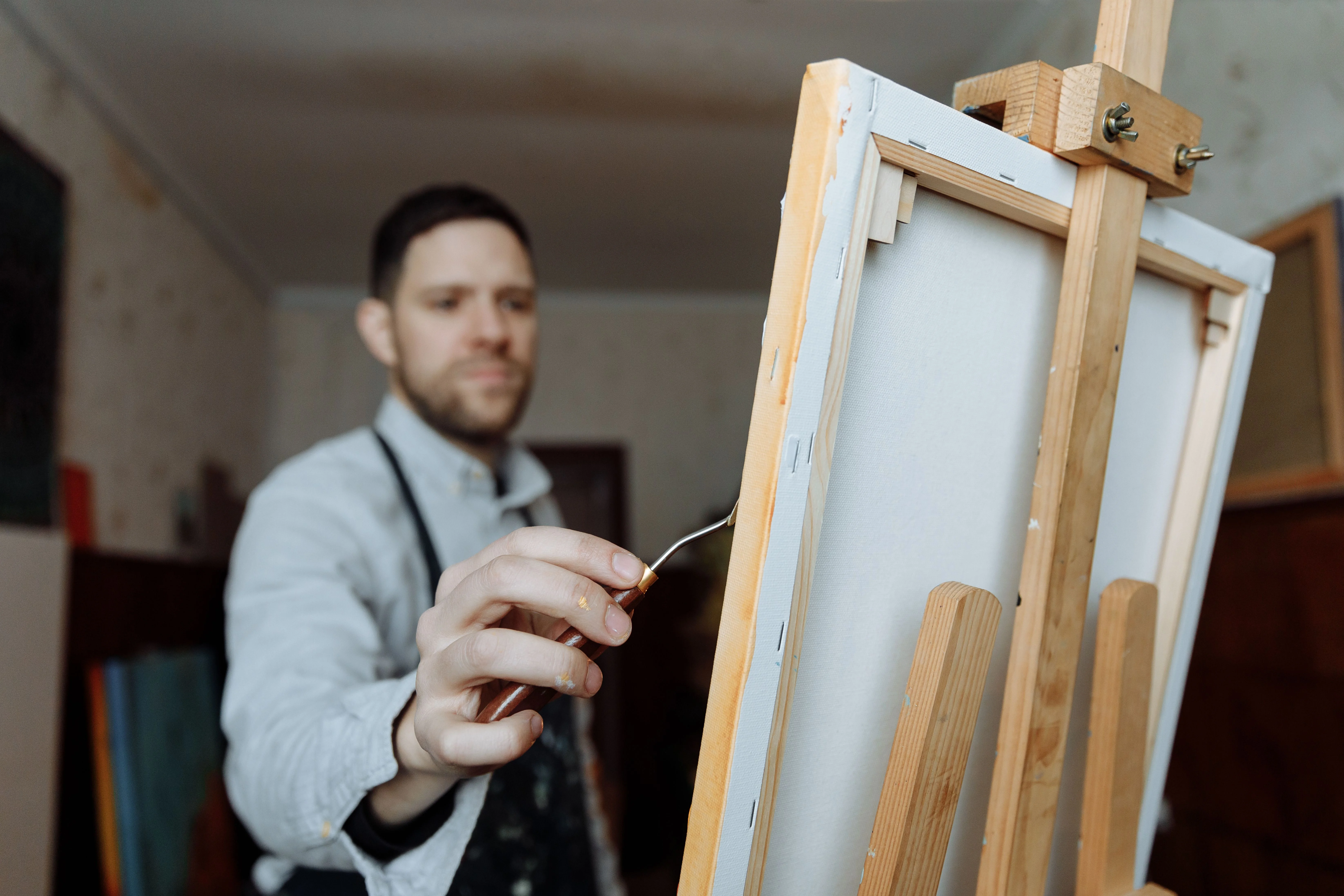 Man painting on a canvas in a studio