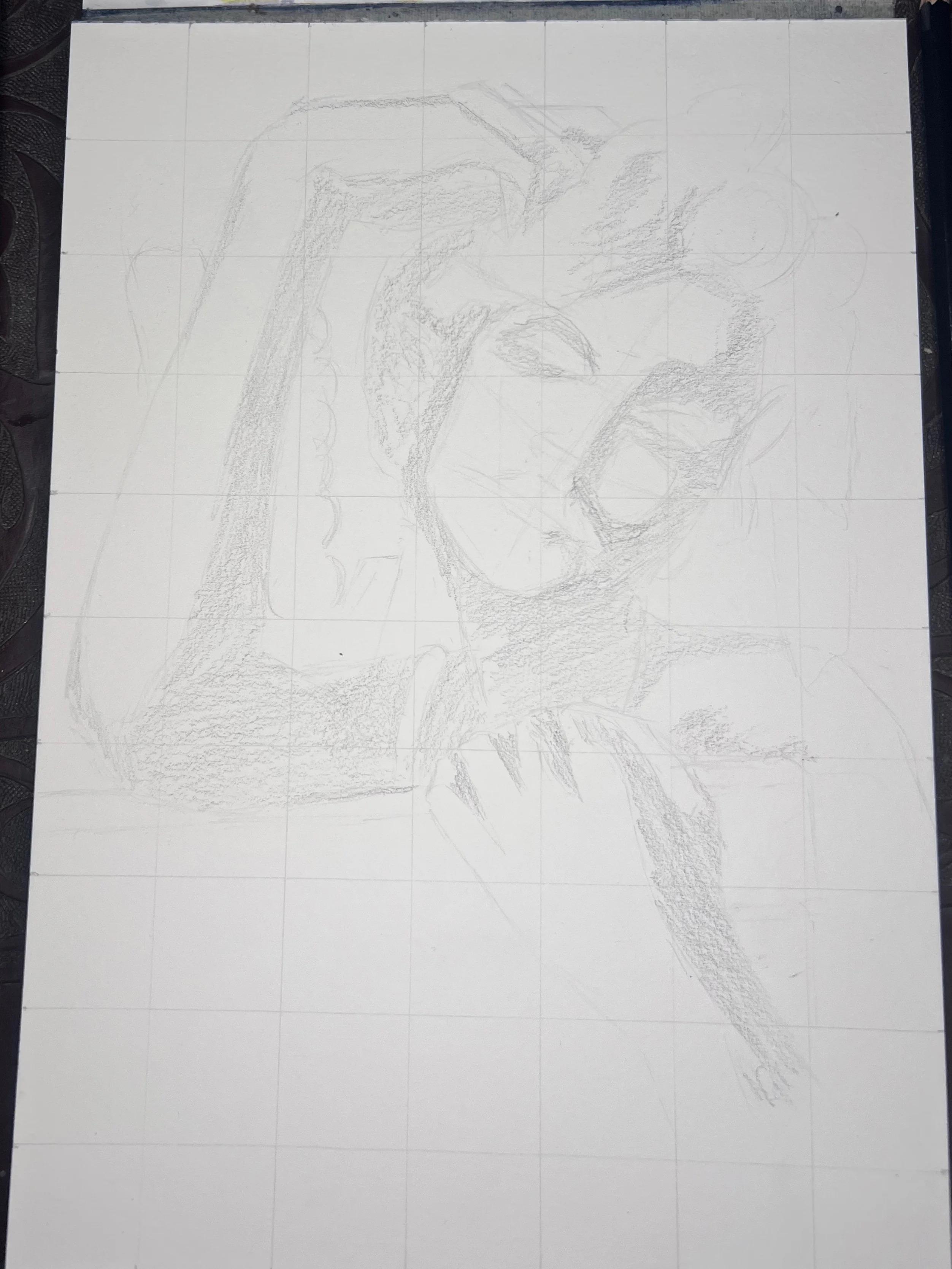 Filling in the shadow areas of the portrait with graphite